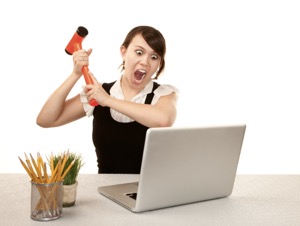 Frustrated woman slamming a laptop